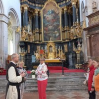 Abt Dr. Pius Maurer mit Besuchern vorm Hochaltar